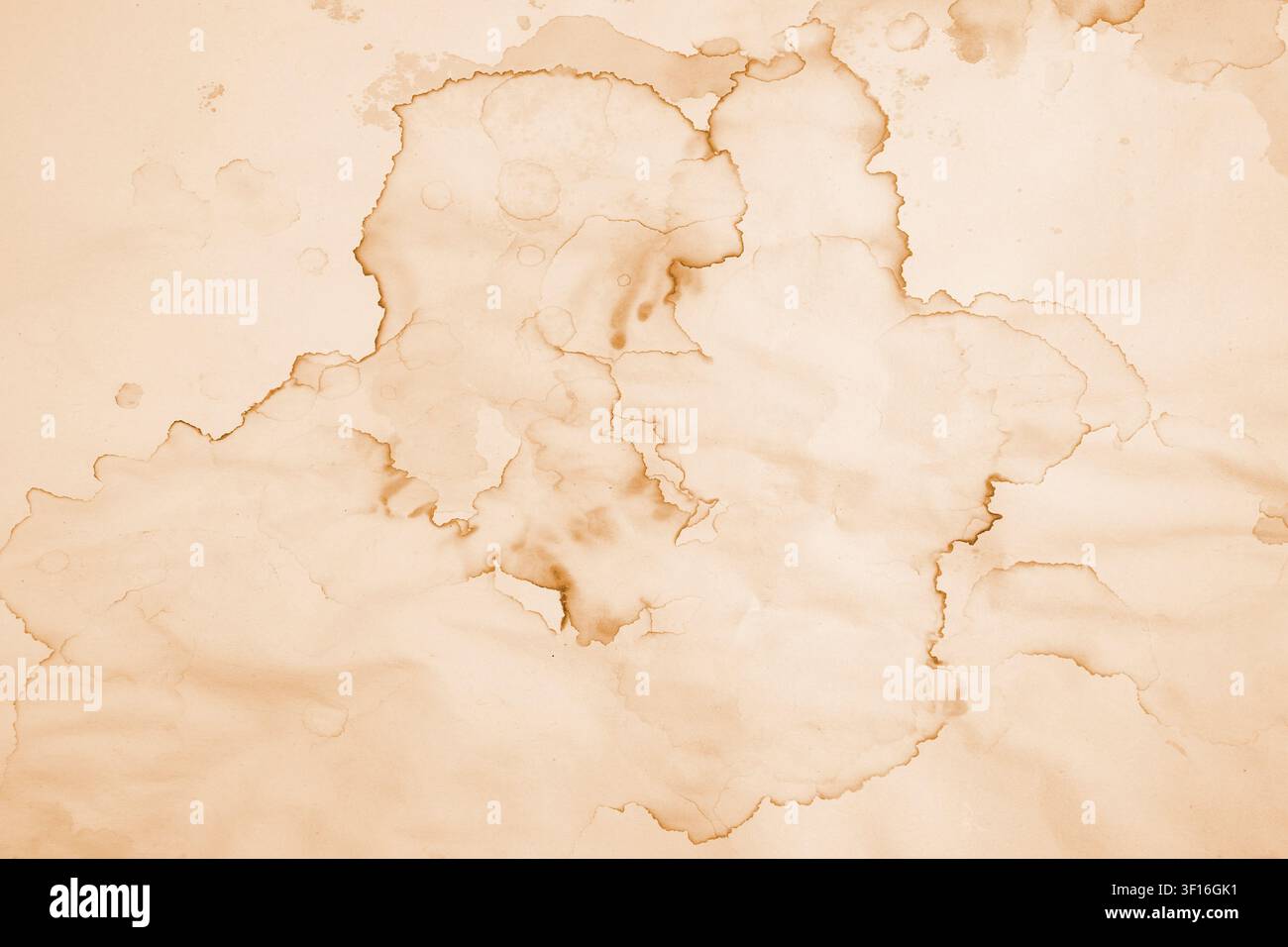 Water damaged beige paper with brown marks and coffee stains, abstract backdrop or overlay template Stock Photo