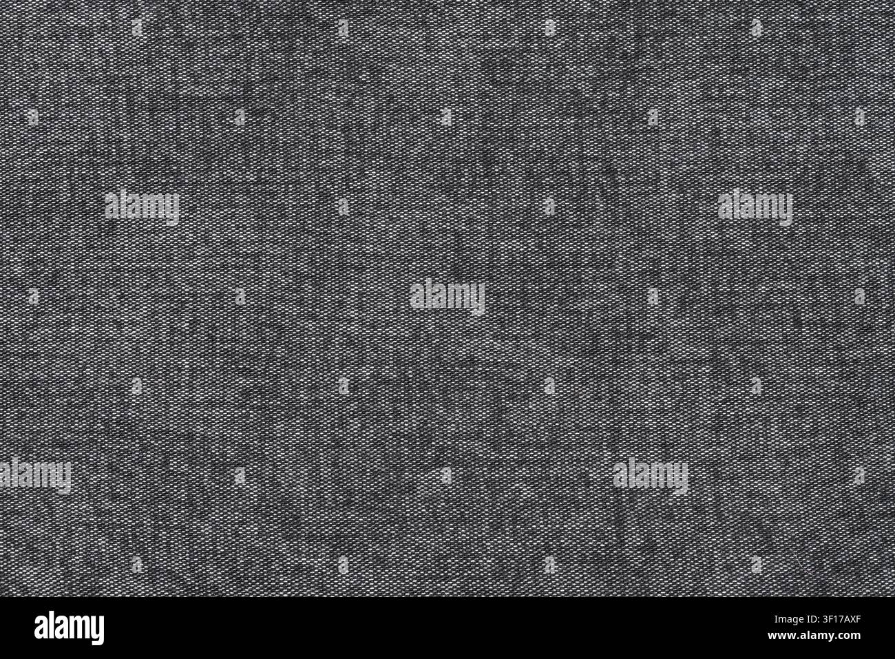 Detailed macro view of dark gray woven fabric with fine texture subtle tonal variations. Neutral color palette uniform pattern suitable for background Stock Photo