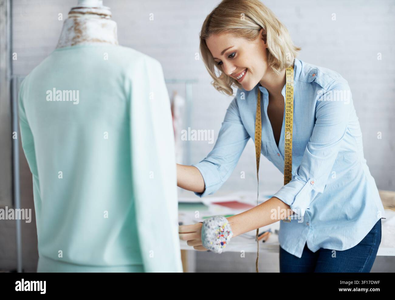 Check, fabric and woman with mannequin in startup, adjusting or fashion designer with measuring tape. Design, seam and happy person with sewing Stock Photo