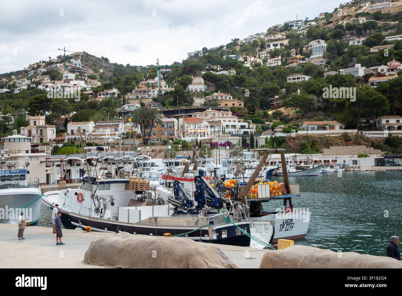 Fishing boats in the harbour at the fishing port of Javea (Xàbia), a town on the Costa Blanca in eastern Spain. Stock Photo
