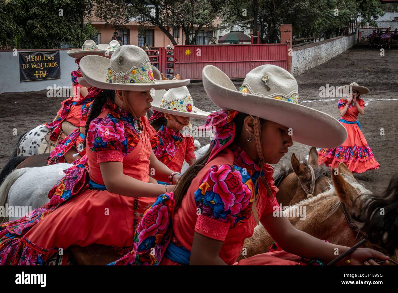 Young Charras or female riders compete in formation riding during an Escaramuza in Mexico City, Mexico Stock Photo