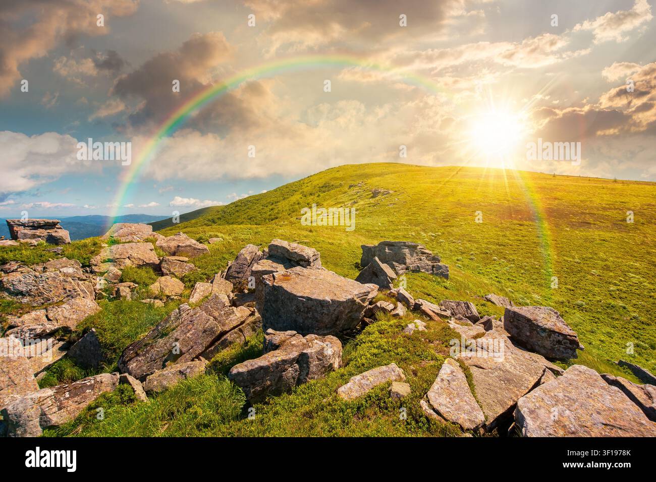 sunset over carpathian mountain landscape in summer. nice background for outdoor adventure in evening light. transcarpathia green hill with rocks Stock Photo