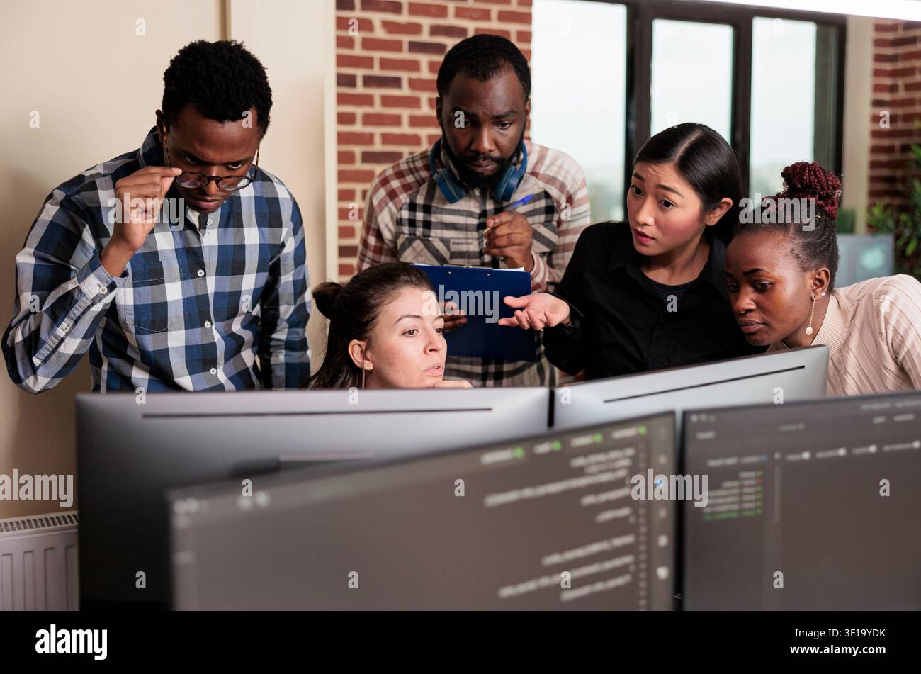 Tech engineers program cybersecurity application together with code, databases and network security work focused on data protection, firewalls and software development Stock Photo