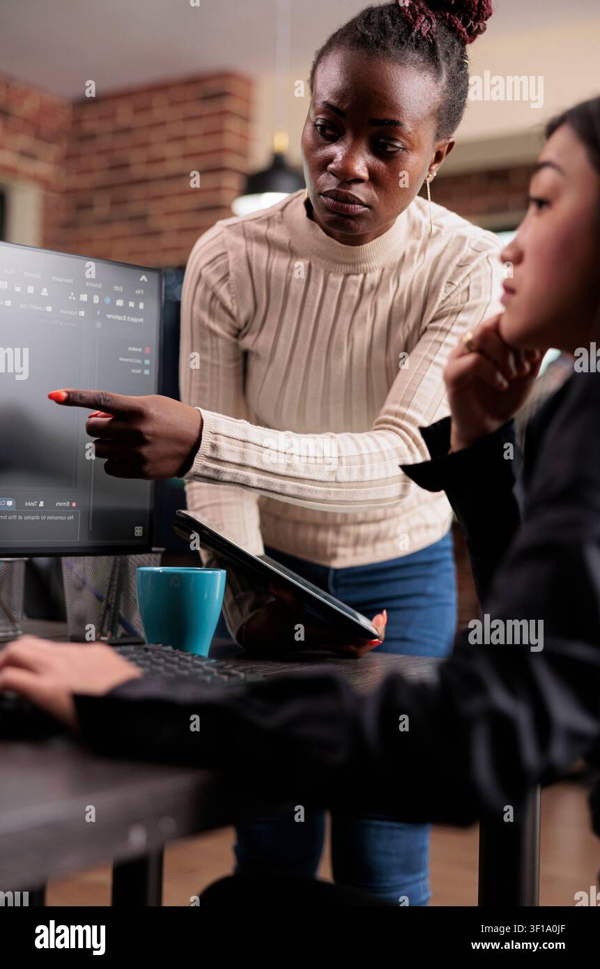 Software developer points at cloud database error with code, databases and network security work focused on data protection, firewalls and software development Stock Photo