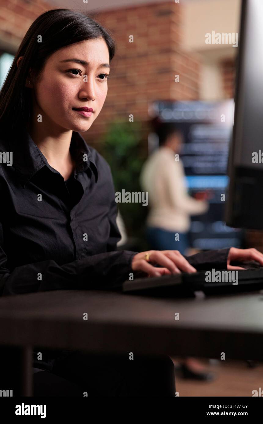 Application developer encrypting cloud storage database by updating network algorithm captures data protection, software systems and secure infrastructure in a technology workspace. Stock Photo