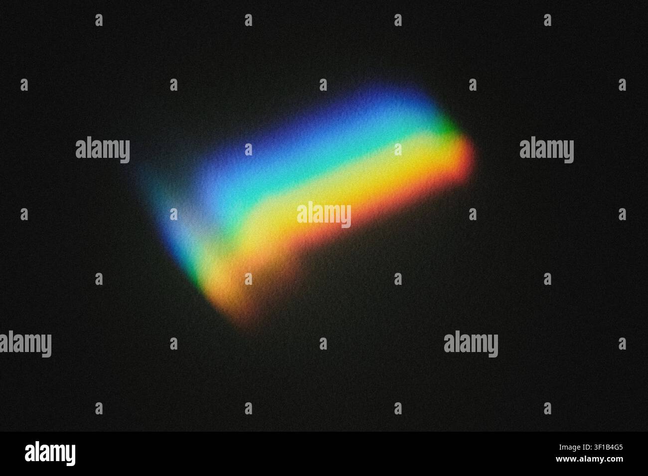 Light refracting through prism creating vivid rainbow spectrum on black surface Stock Photo