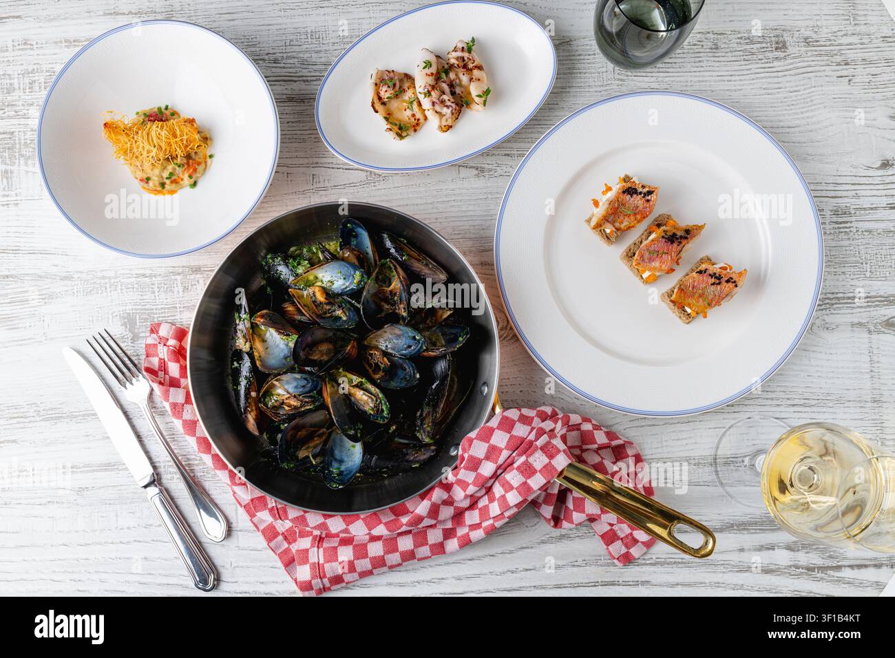Overhead seafood table with mussels and assorted gourmet appetizers Stock Photo