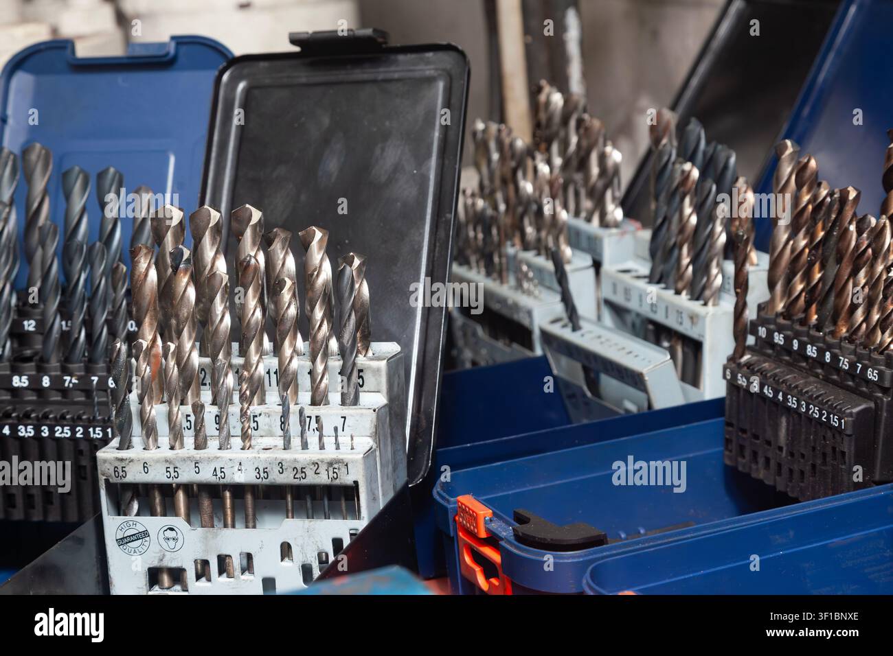 Sets of drills on a table in a workshop Stock Photo