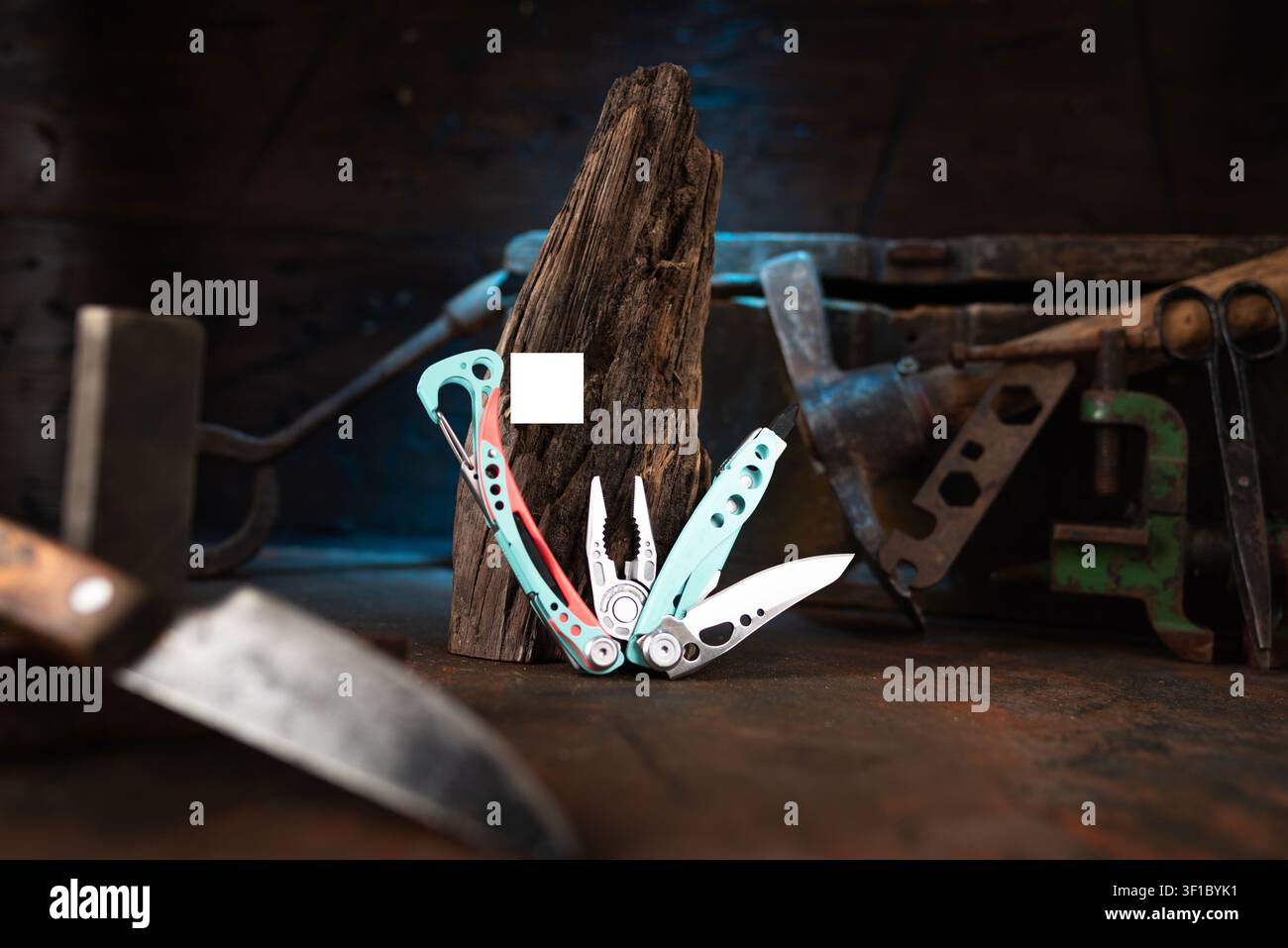 Modern multitool with vintage tools on a dark wood background. Stock Photo