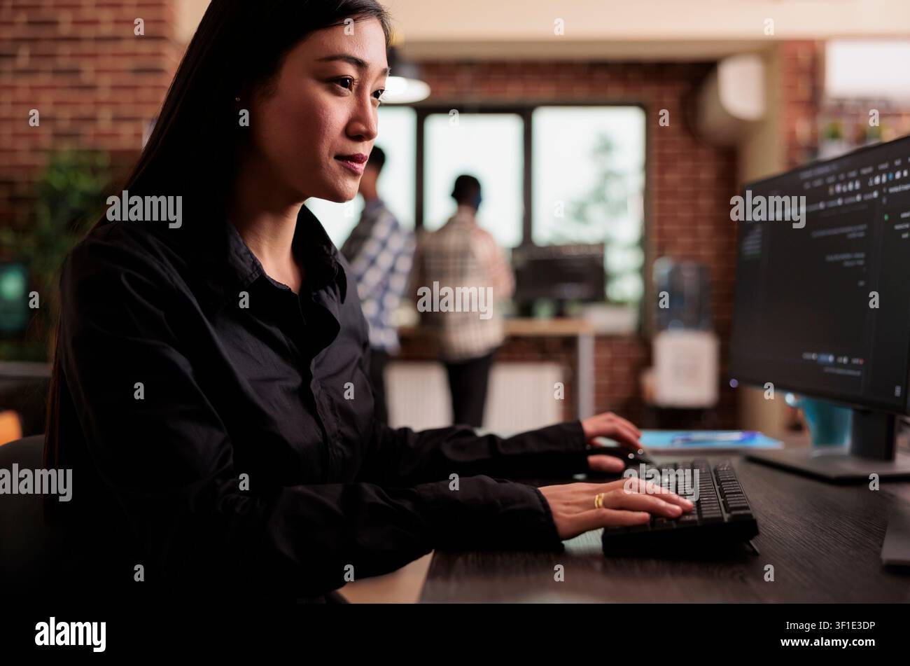 Software developer writing javascript code on terminal window, working with computer displaying coding algorithm, asian tech engineer programming big data in company office. Stock Photo