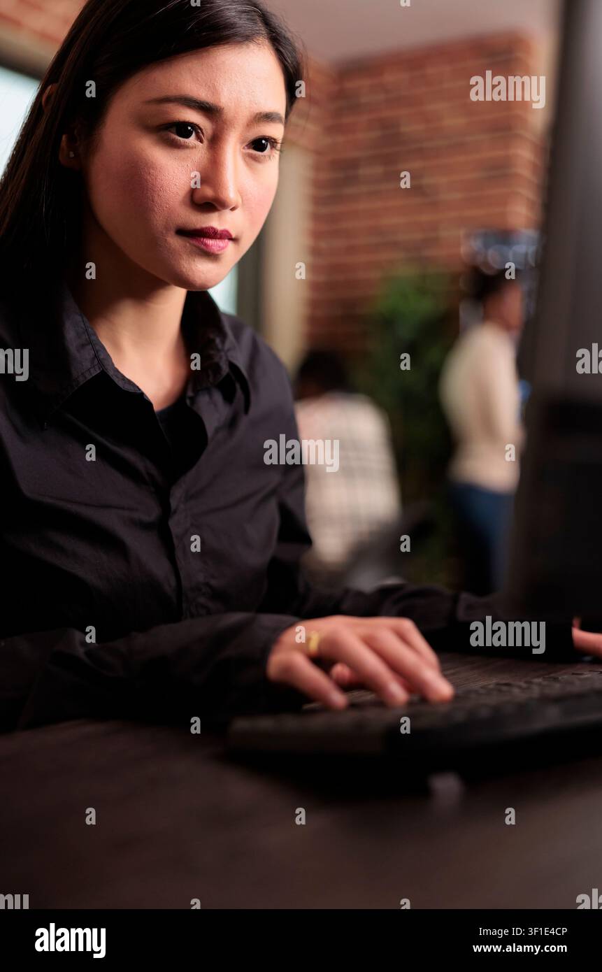 System engineer developing a company software project in a programming workspace, connecting source code, database logic and collaborative development for a technology project. Stock Photo