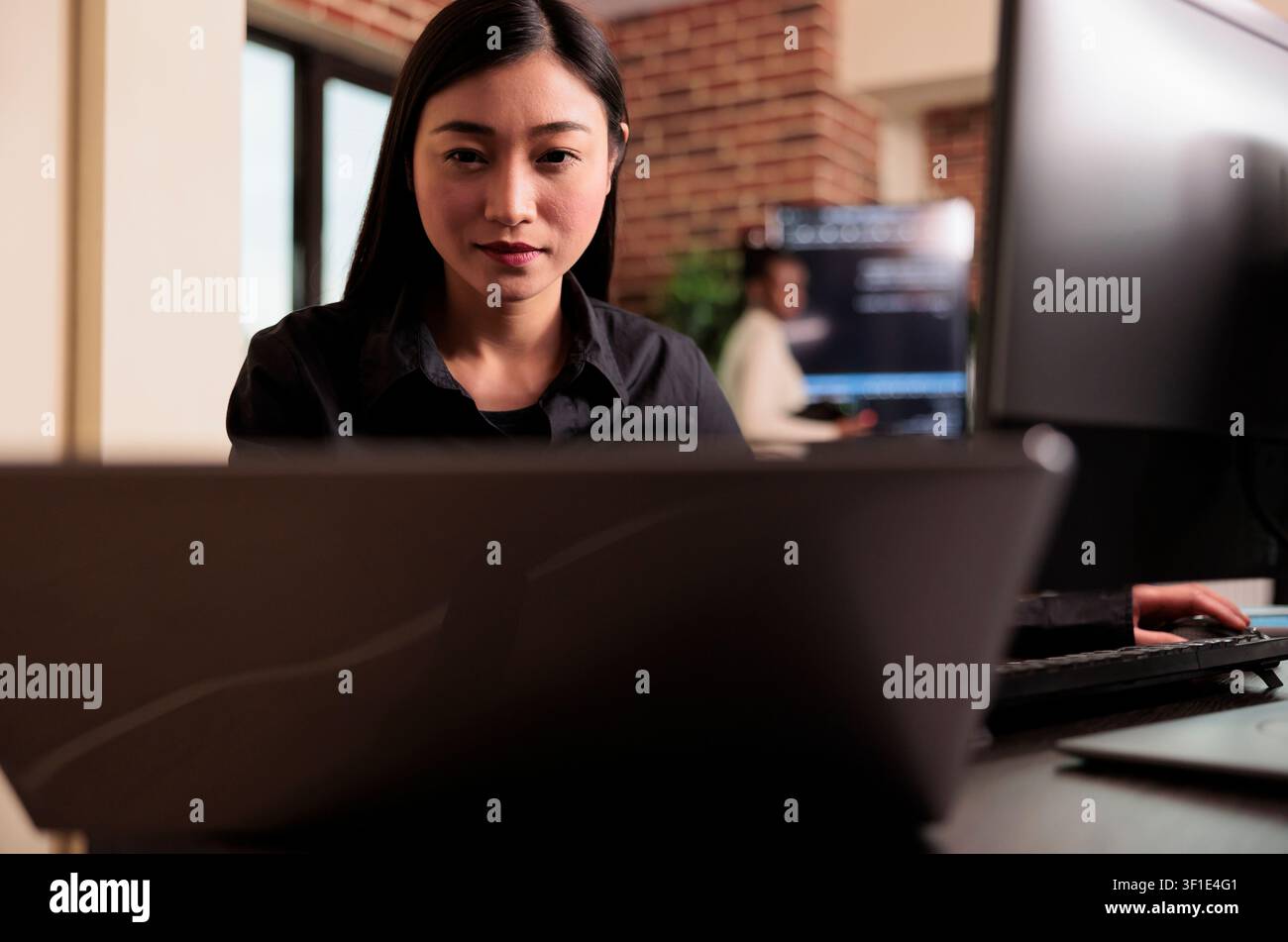 Asian tech engineer analyzing compiling html code on computer display, working on interface development, software developer using terminal window with firewall server data in it big data agency. Stock Photo