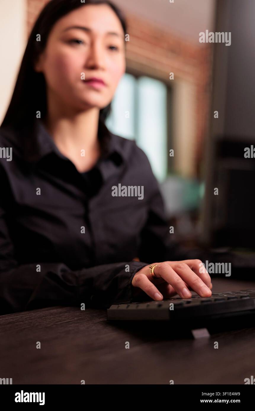 Software developer programs server code at a computer desk in an IT agency, focused on HTML algorithms and digital development workflow. Stock Photo