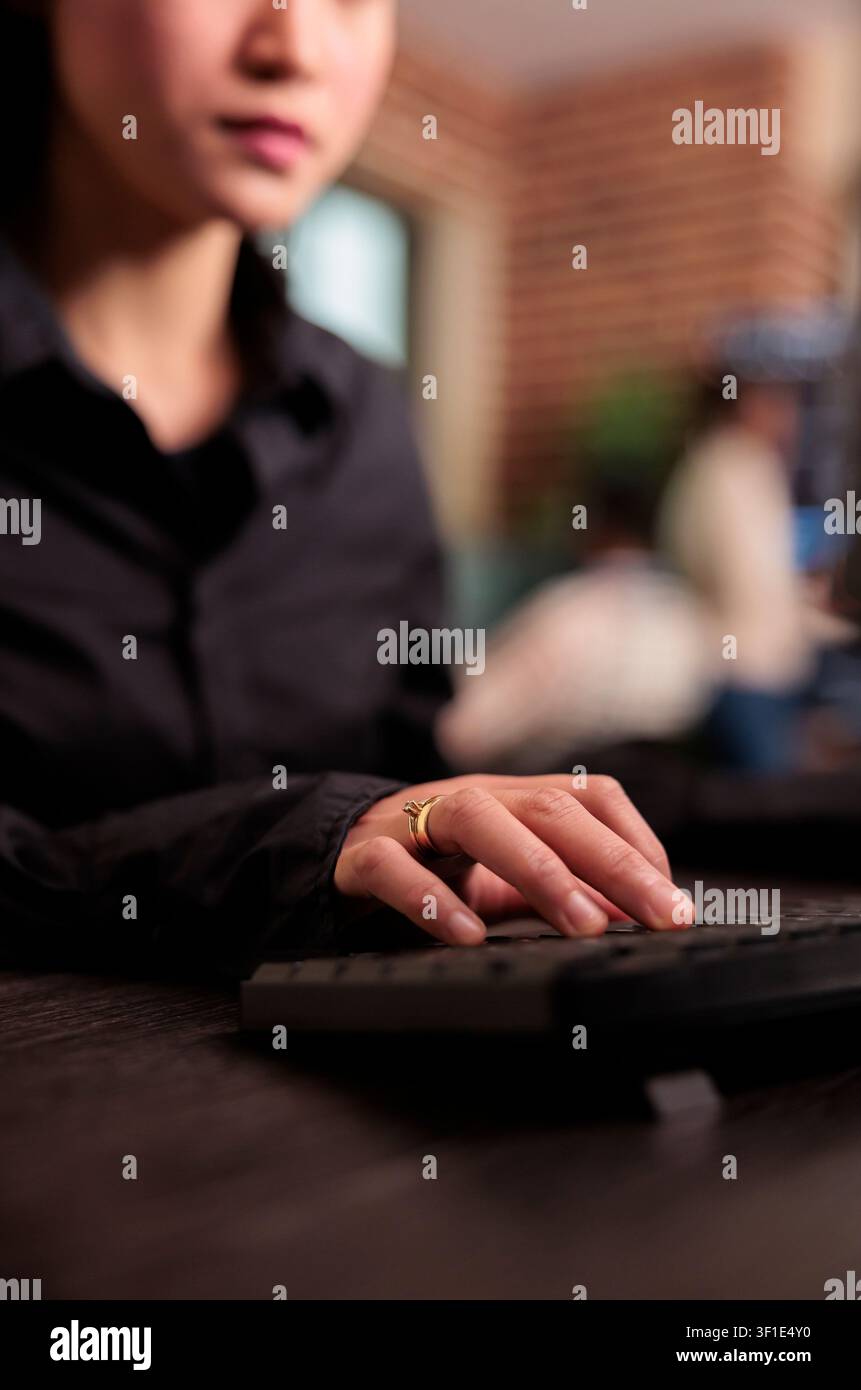 Freelance coder programs a server algorithm at a computer desk, building software code and development logic in an IT office, connecting paperwork, planning and professional workflow. Stock Photo