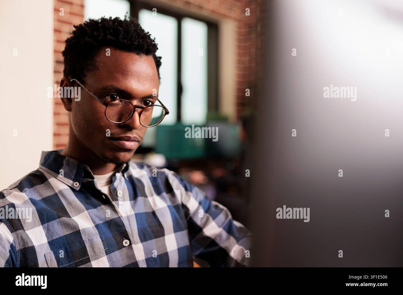 System engineers type JavaScript code in a terminal window, working on software development and screen-based programming tasks, connecting paperwork, planning and professional workflow. Stock Photo