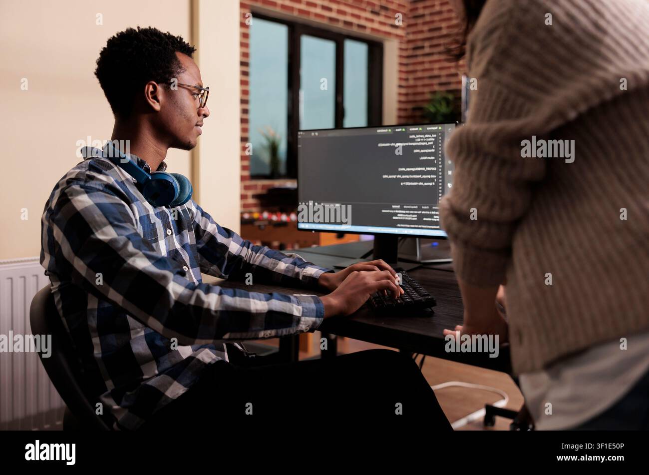 Diverse cloud programmers use computers to develop algorithm programs, build user interfaces and work with terminal windows in a software company. Stock Photo