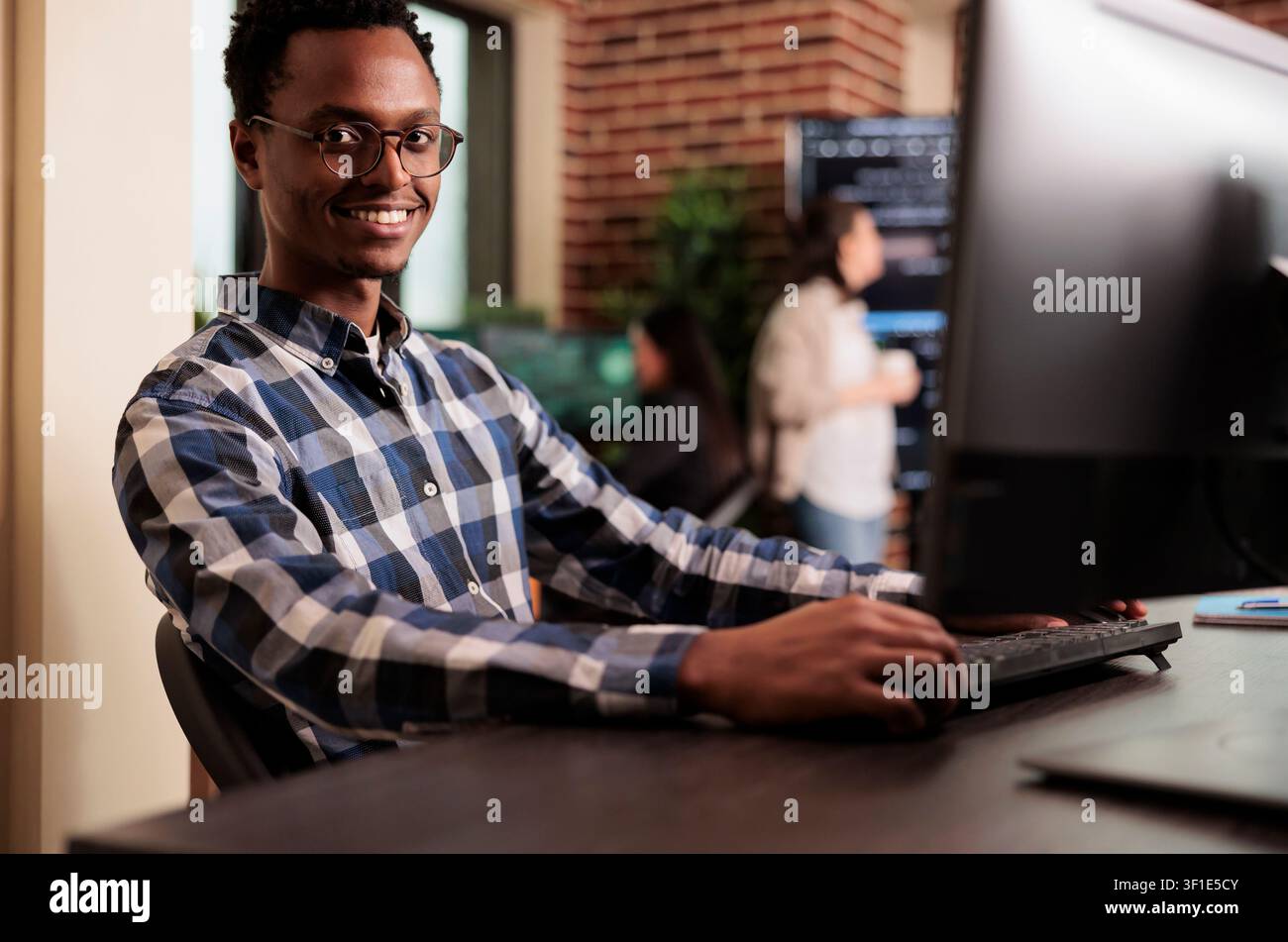 African american developer working on software program in it programming agency, utilizing skills in coding and technology to create more inclusive program, web programer writing html script. Stock Photo
