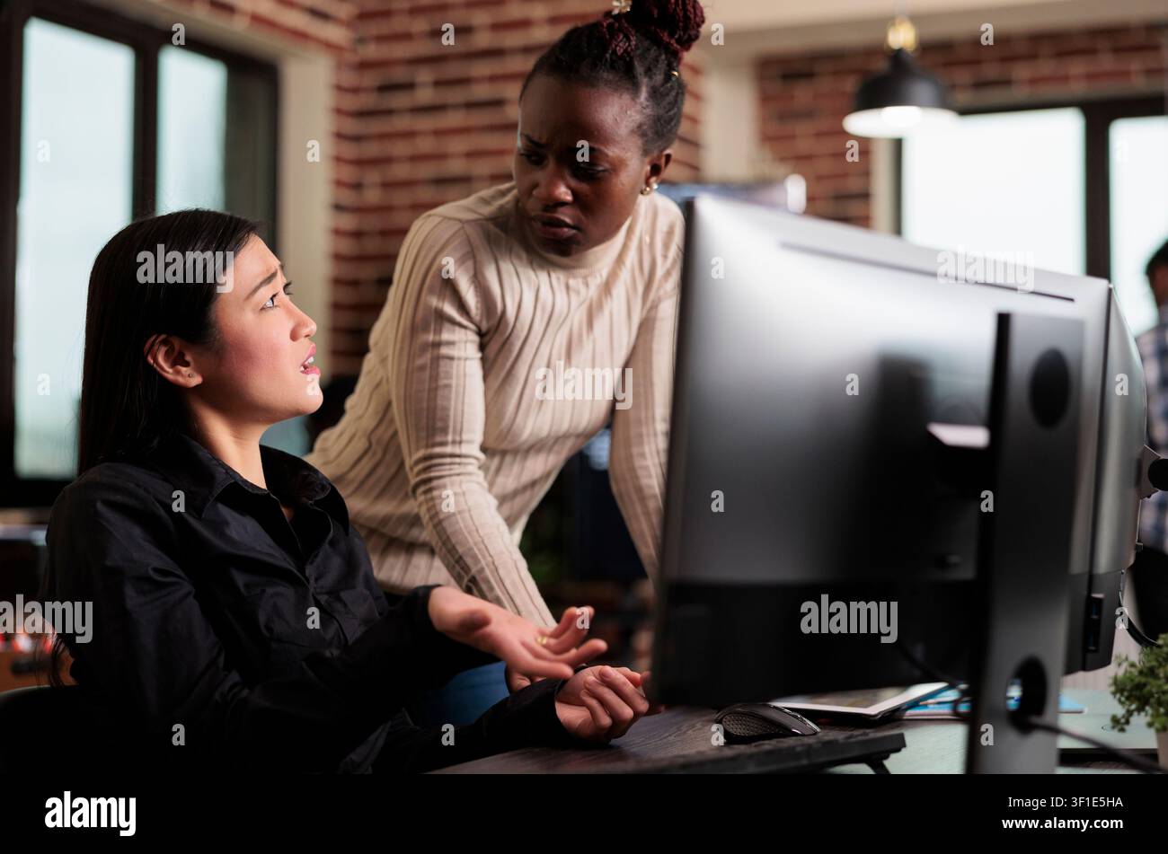 Worried cyber security team members thinking of methods to update defence system without turning it off, software engineers developing cloud storage network and intelligent algorithm. Stock Photo