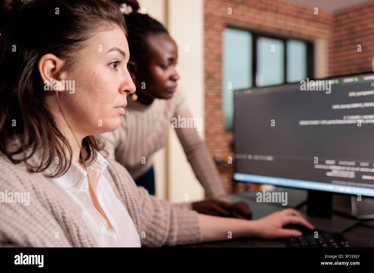 Engineers writing server code at workstation in server room while working with code, screens and digital infrastructure for software development. Stock Photo