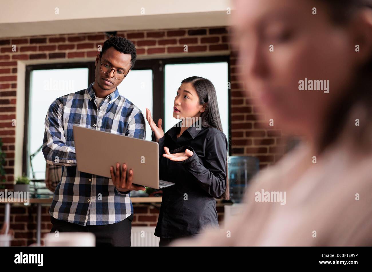 Software developers analyze encrypted files for malware while monitoring internet bandwidth and data security in a cybersecurity agency. Stock Photo
