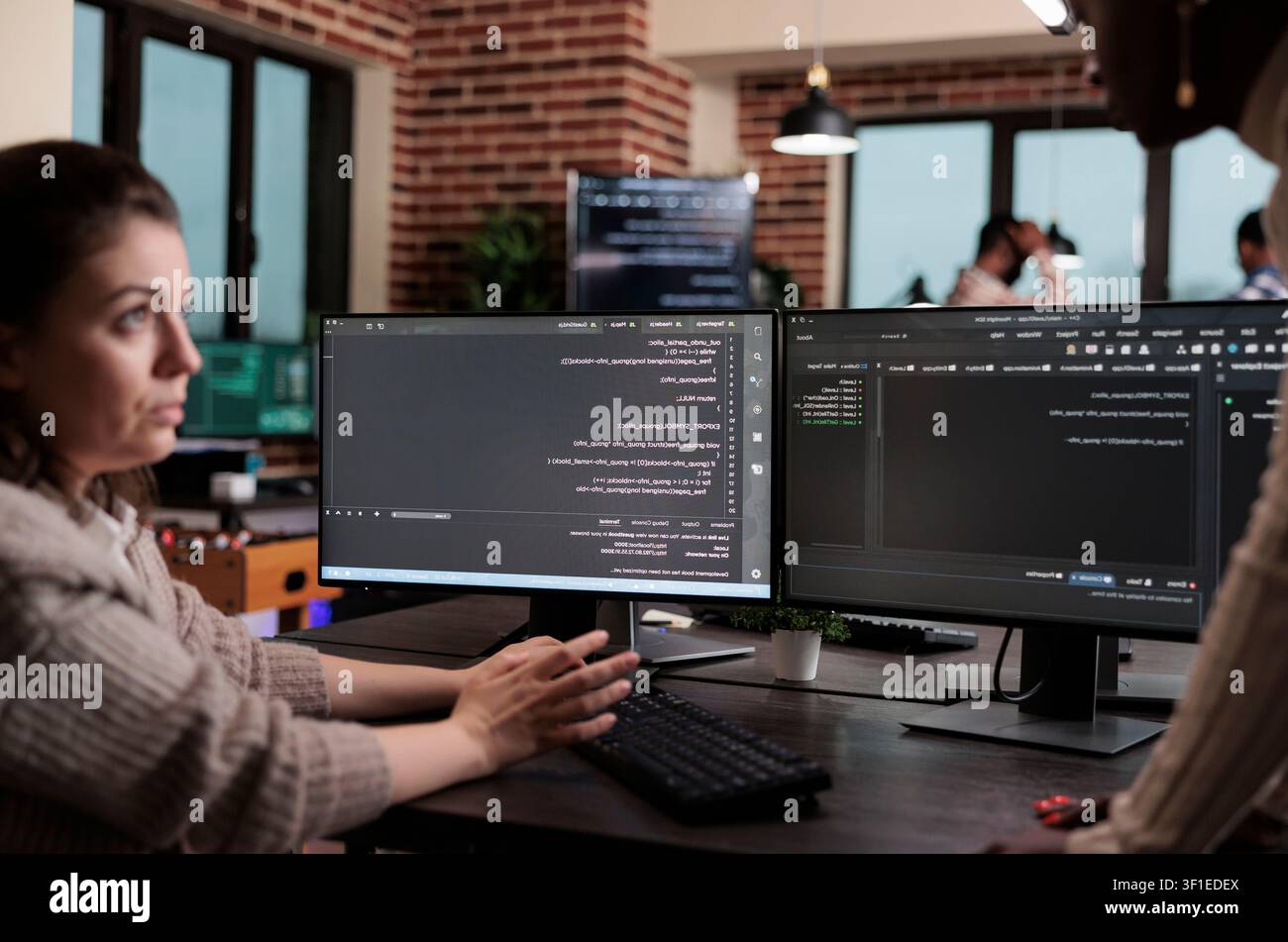 Programming team searches for cyber attack sources and security coverage while developing encryption applications for stronger system protection. Stock Photo