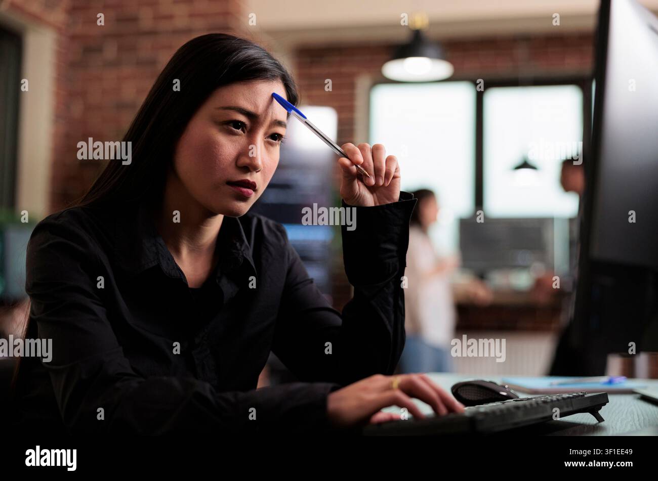Thoughtful developer planning encryption program upgrade during a focused IT task involving diagnostics, digital infrastructure and secure data processing. Stock Photo