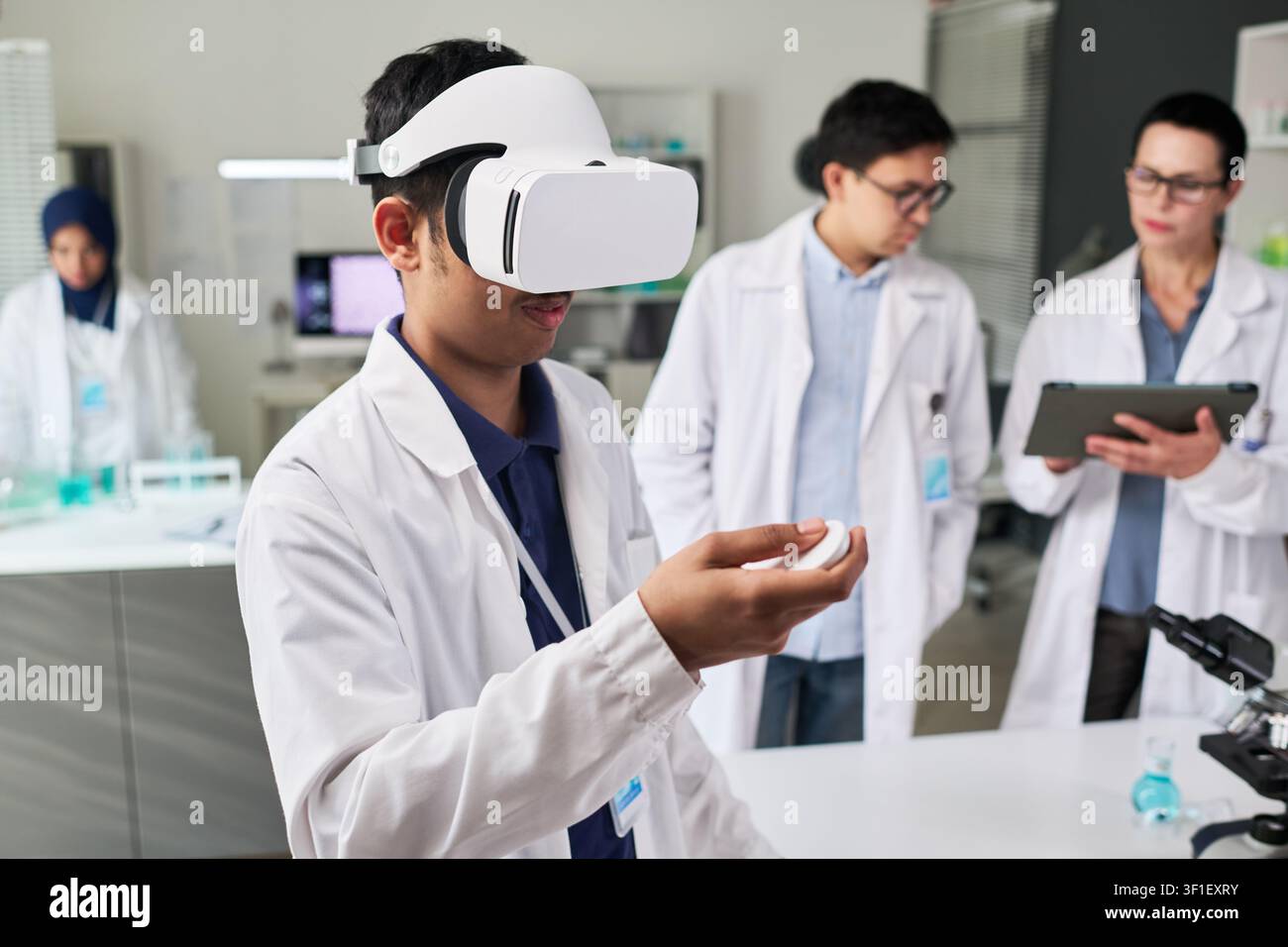 Indian Man Using VR Headset in Science Lab Training Stock Photo