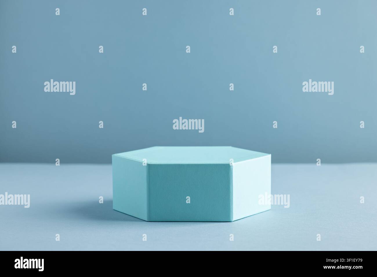 Minimalist Hexagonal Box on Monochromatic Blue Background for Modern Design Stock Photo