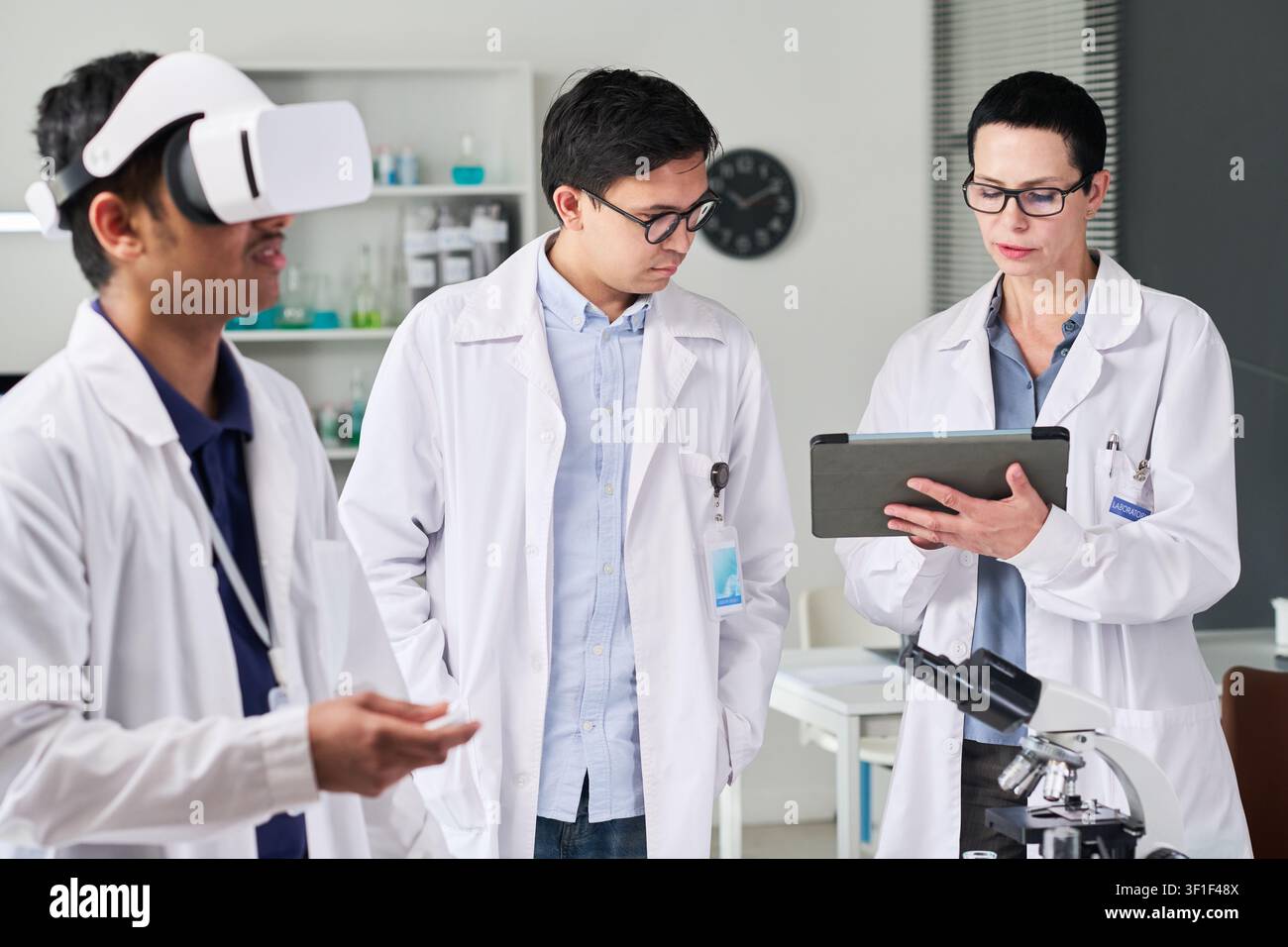 Indian Man Using VR Headset during Medical Research Team Training Stock Photo