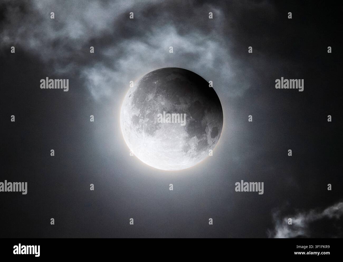 Full Moon During a Partial Lunar Eclipse Behind Clouds Stock Photo