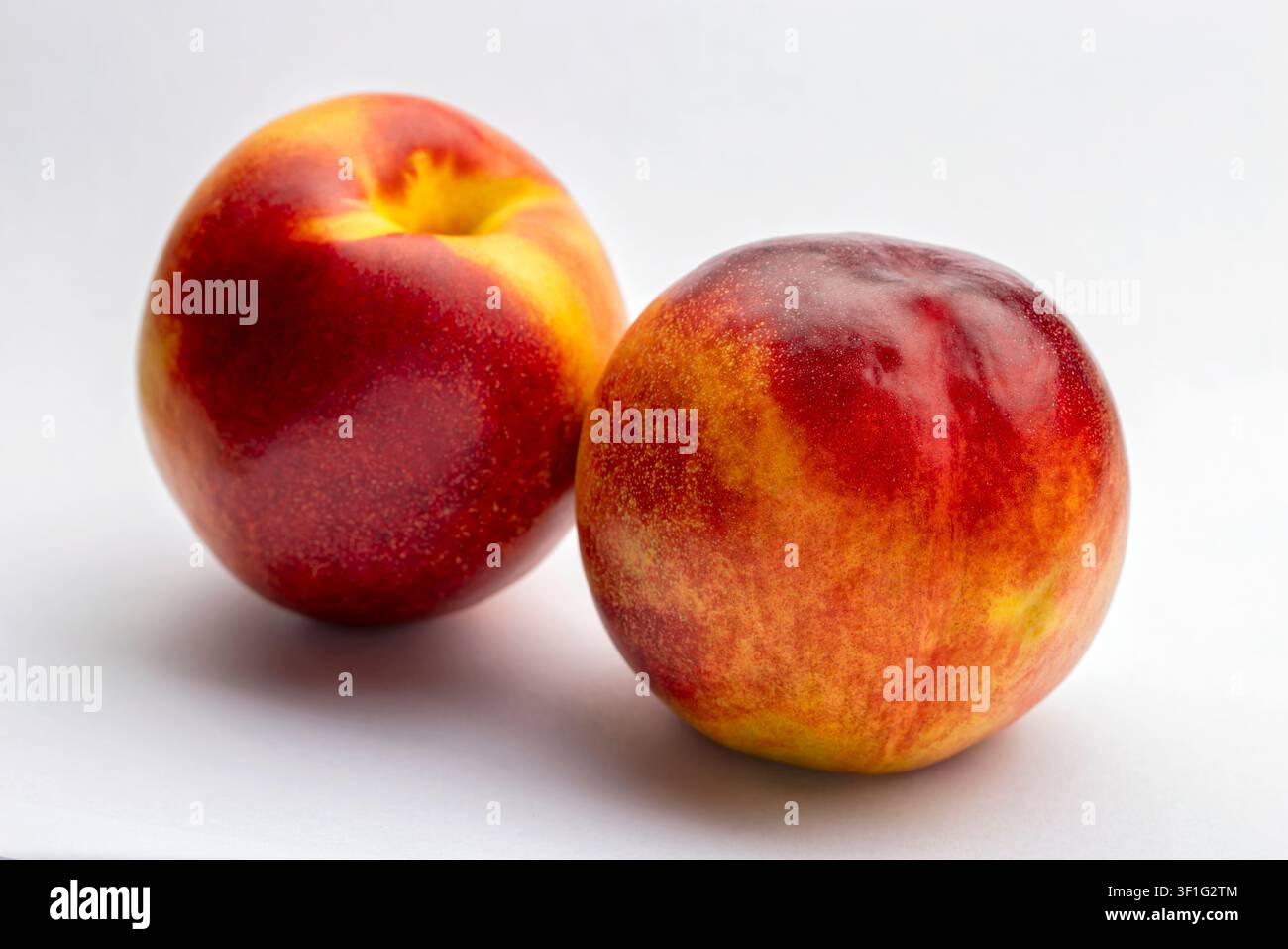 Two ripe nectarines fruit isolated on white background Stock Photo