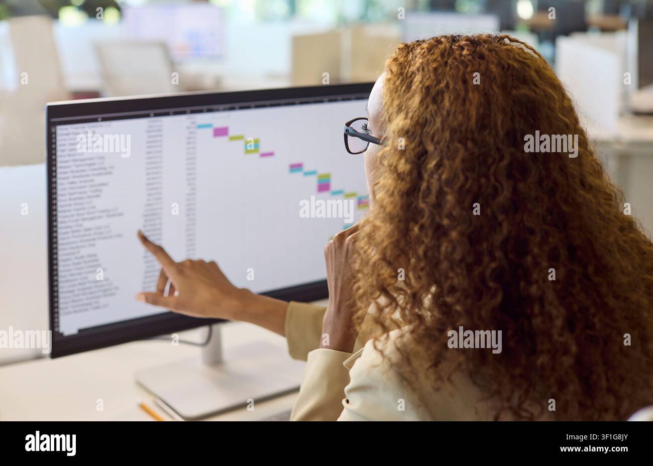 Accountant analyzing spreadsheet timeline on computer in modern office for finance Stock Photo