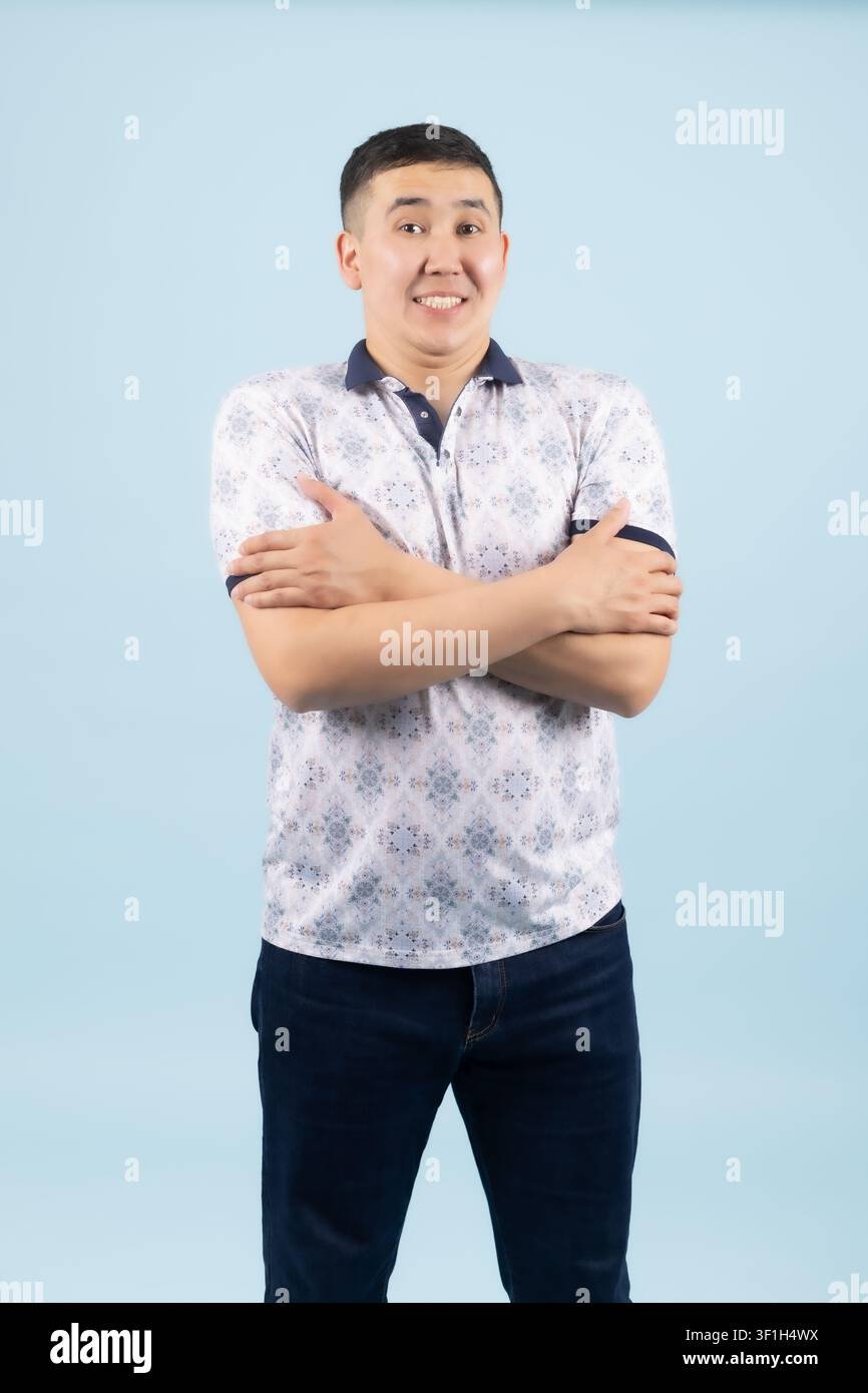 Young male standing confidently with crossed arms looking forward Stock Photo