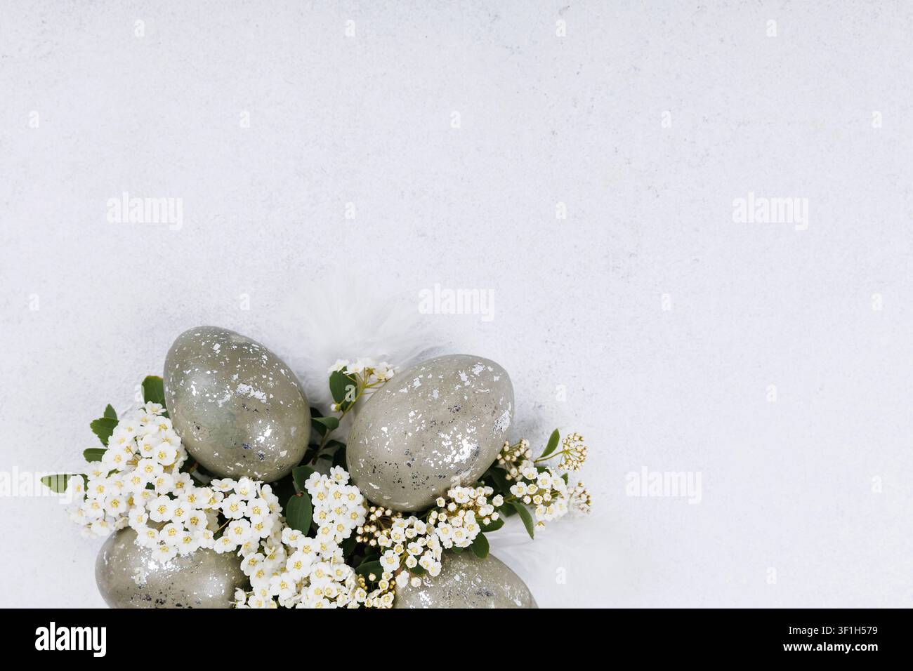 Easter eggs with white blossom flowers spring flat lay Stock Photo
