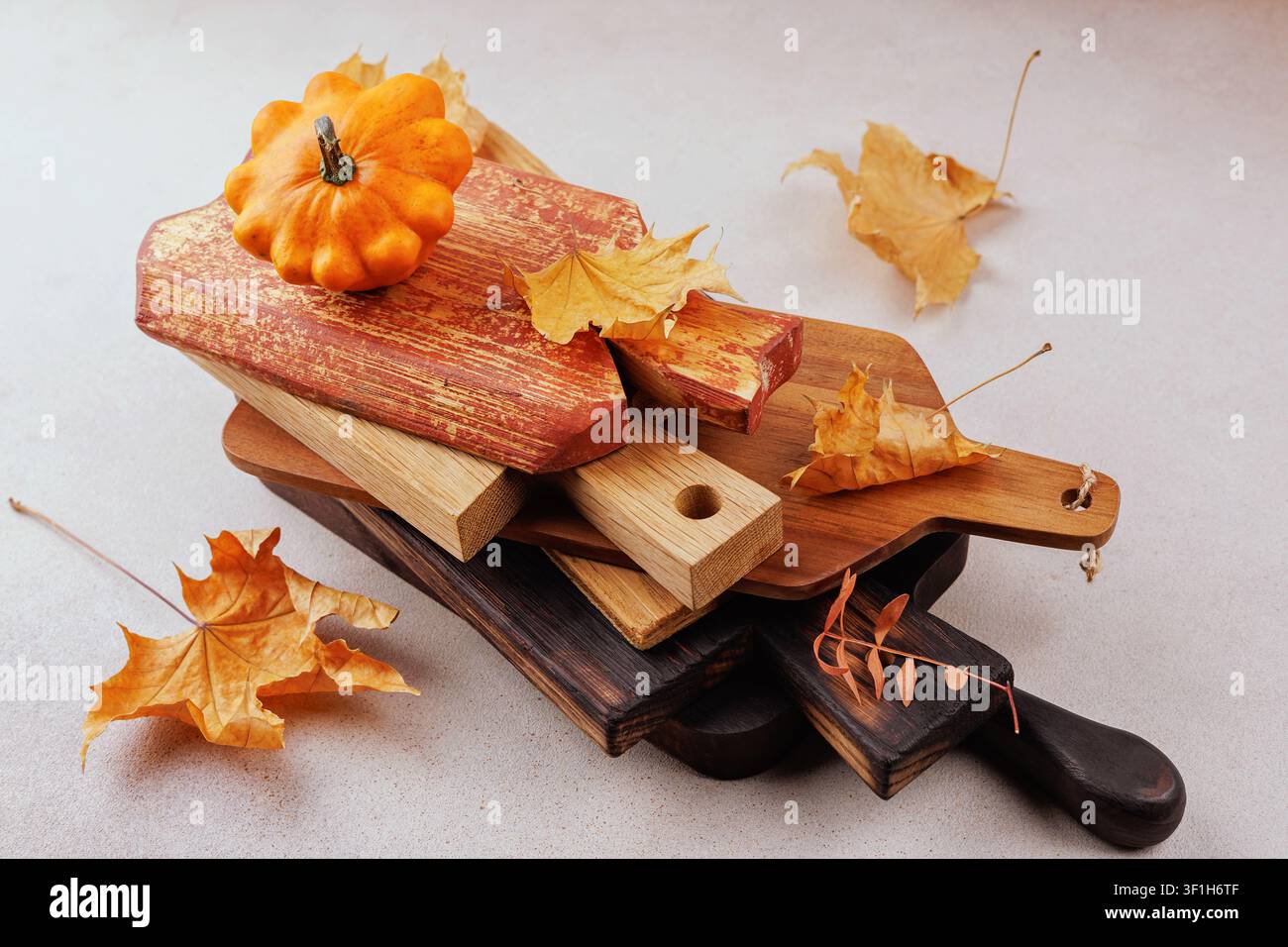 Fall decor with stacked boards and orange pumpkin Stock Photo