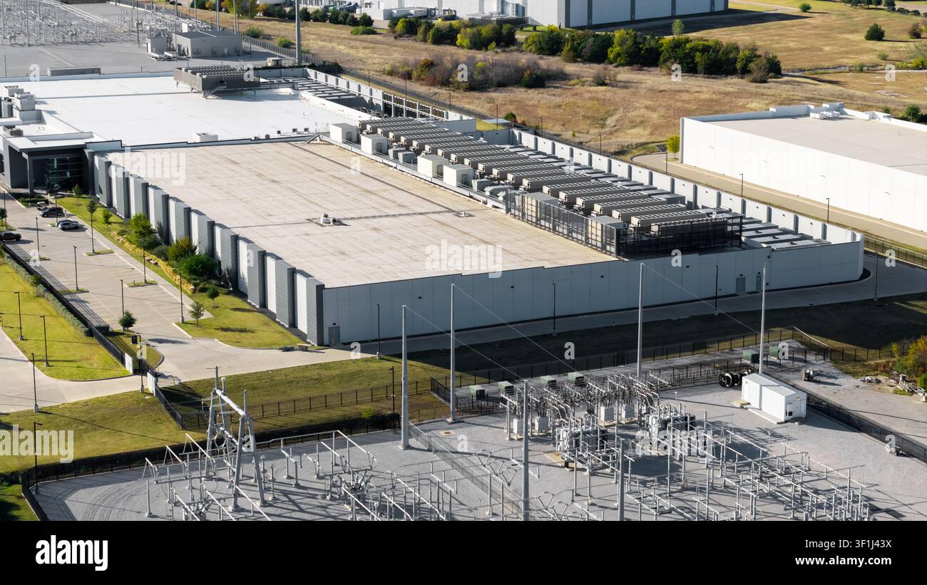 Large data center building processing information with an adjacent power substation Stock Photo