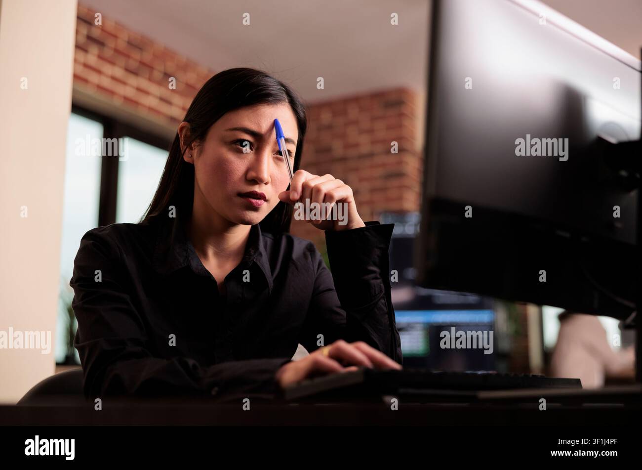 Tired tech engineer brainstorming ideas about coding solution, finding algorithm to create database script, feeling pensive and thinking about software developing system in it agency. Stock Photo