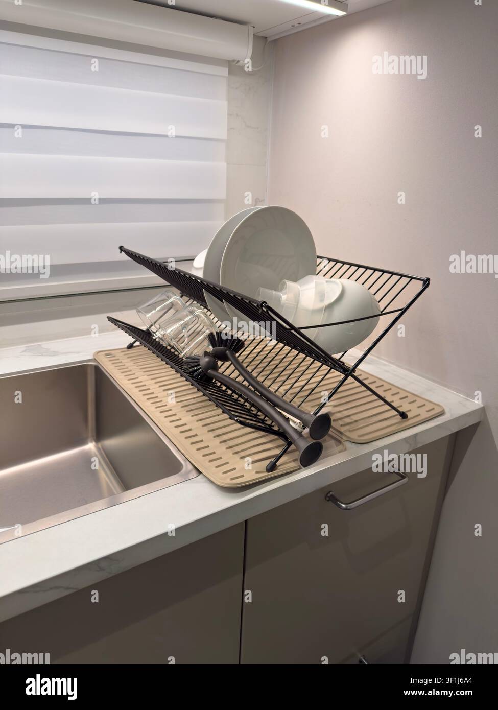 Modern Kitchen Dish Drying Rack with Clean Plates and Glassware Stock Photo