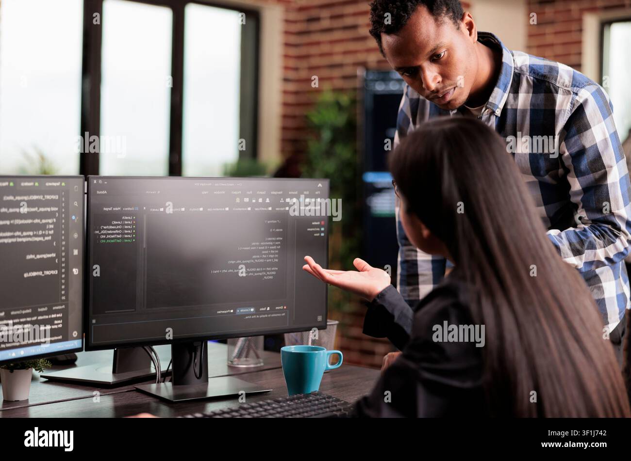 System engineers write binary security code in a development agency, working on programming tasks and protected digital infrastructure. Stock Photo