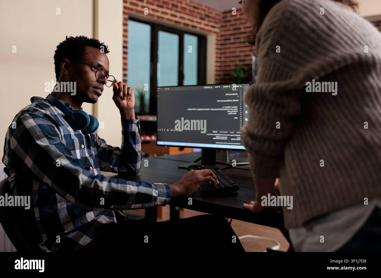 Software developers sitting at desk and developing a functional data encryption system, Multiethnic cyber security team members in agency office writing cloud database processing algorithm. Stock Photo