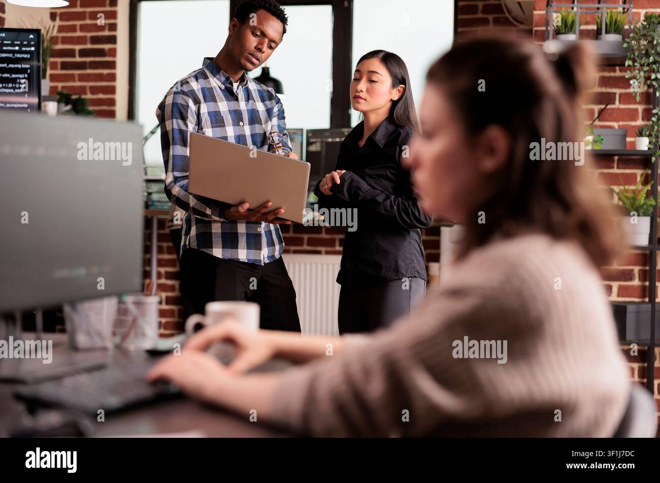 Software developers looking at security firewall on laptop, using html and terminal window, working in it programming office, during a domestic lifestyle moment. Stock Photo