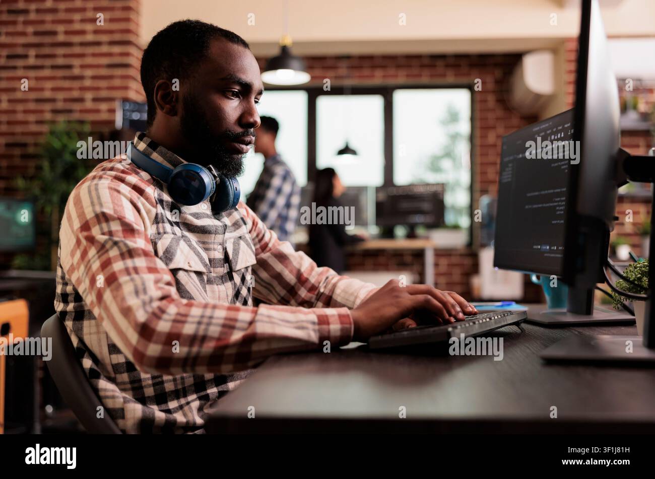 Freelance coder typing javascript code on computer to develop online cloud computing information. Software developer writing html script and data algorithm, working in it programming office. Stock Photo