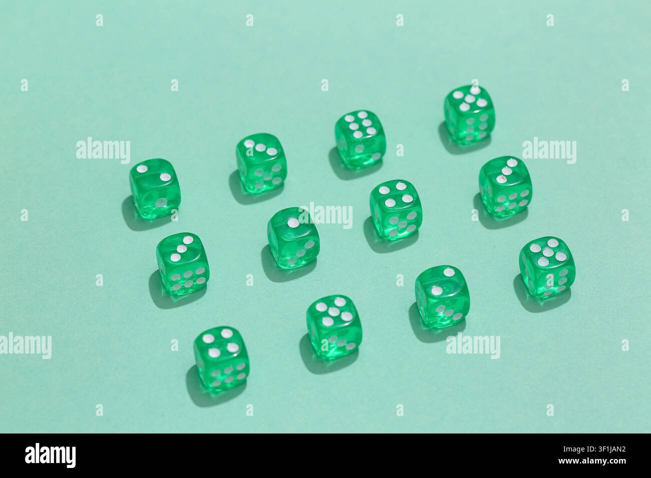 Green game dices on turquoise background Stock Photo
