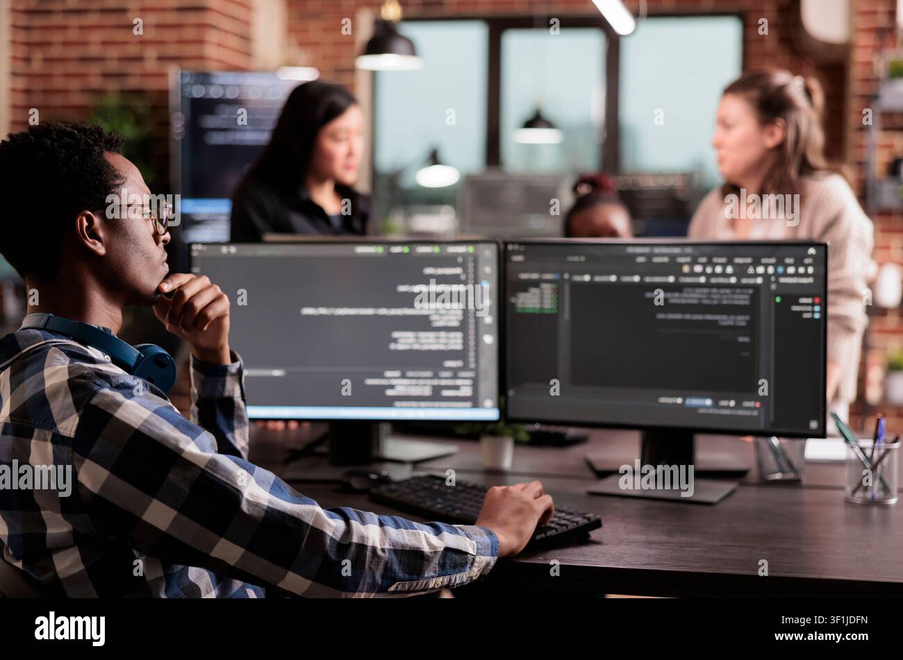 Technology engineer types server code on a computer in an IT agency while creating an online system algorithm and new user interface. Stock Photo