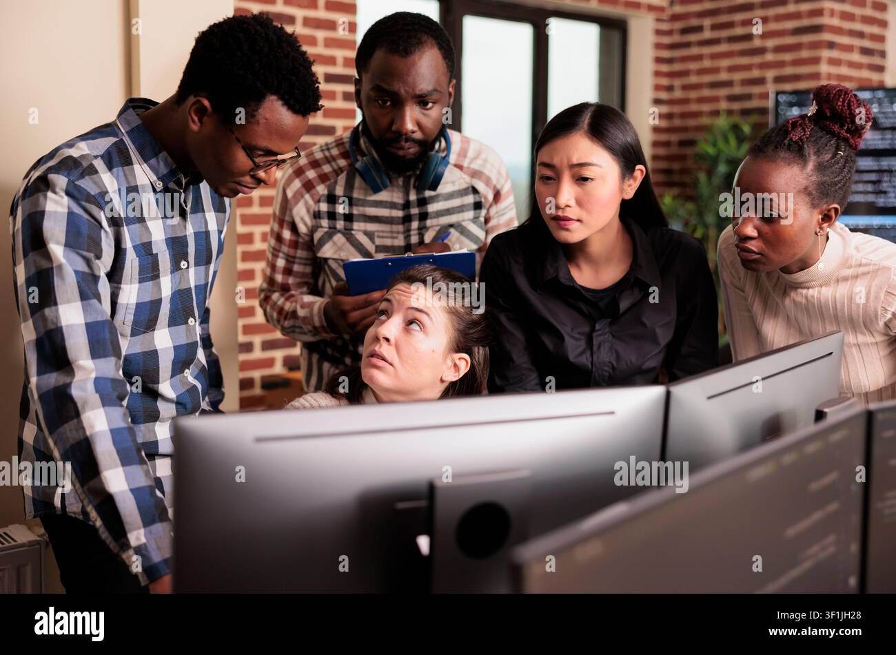 Diverse system engineers analyze HTML script and source code on a computer, compiling application logic in an IT data agency, with code review and debugging context. Stock Photo