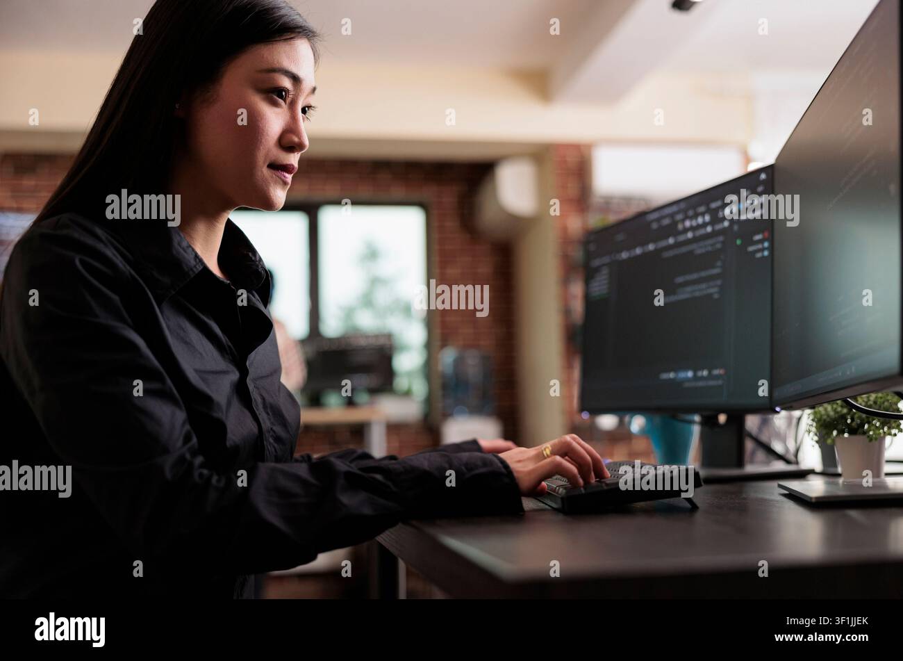 Cybersecurity employee developing blockchain database system during a focused IT task involving diagnostics, digital infrastructure and secure data processing. Stock Photo