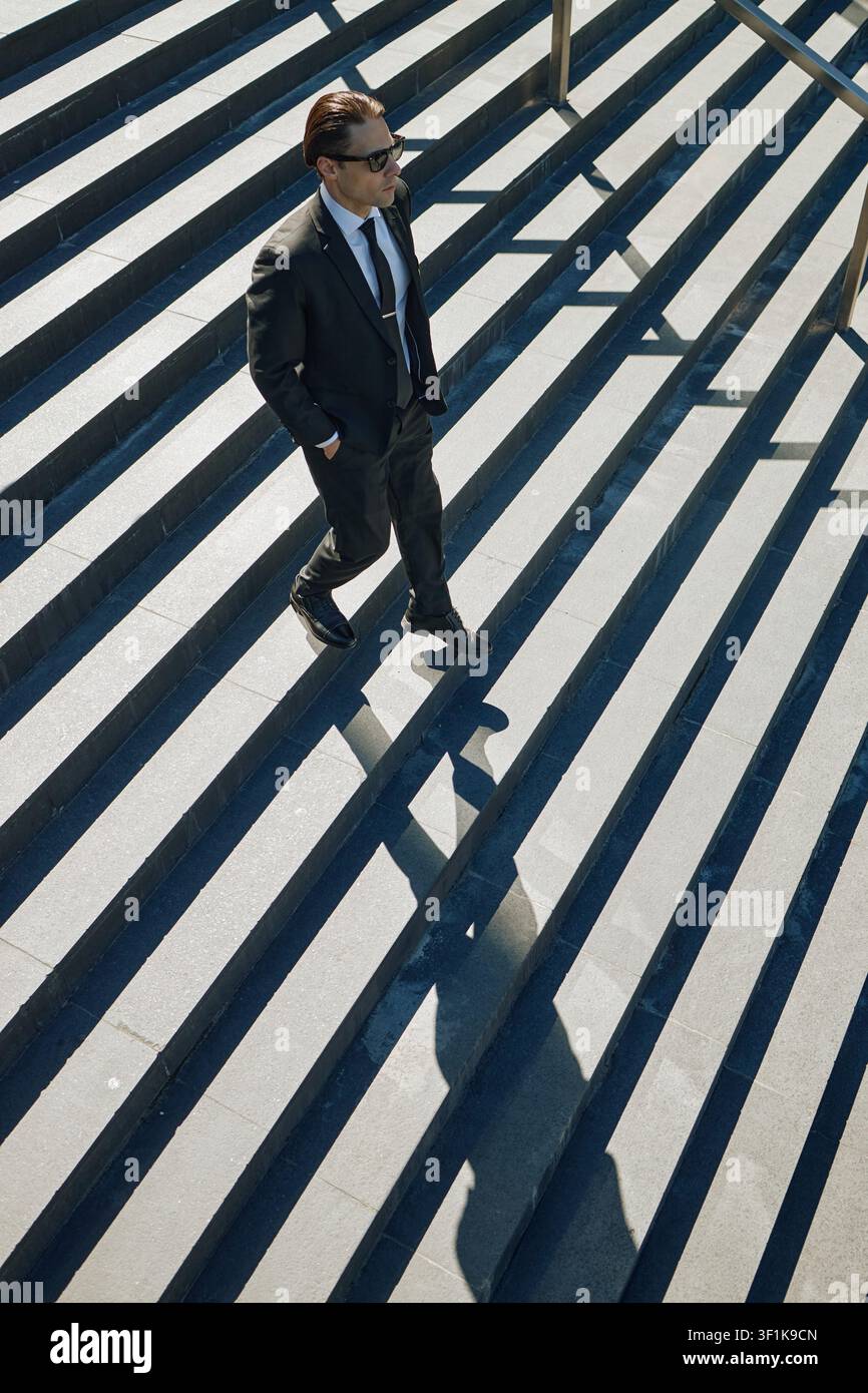 Businessman Walking down Stairs in Urban Corporate Commute Stock Photo