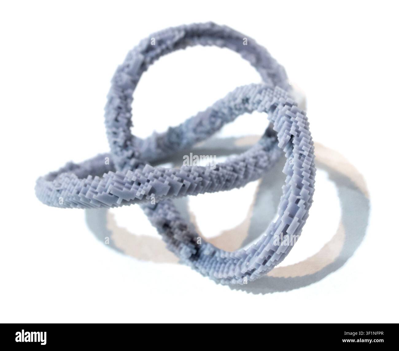 3D printed model of infinity loop. Voxel art style. Model created using photopolymer resin. Object printed on 3D printer from liquid resin isolated on white background SLA technology Stereolithography Stock Photo