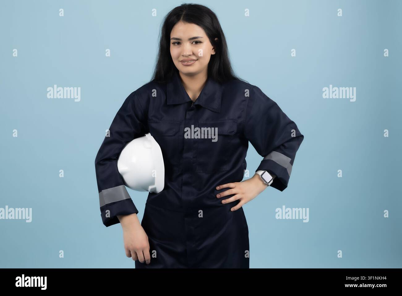 Professional female mechanic standing confidently in the studio Stock Photo