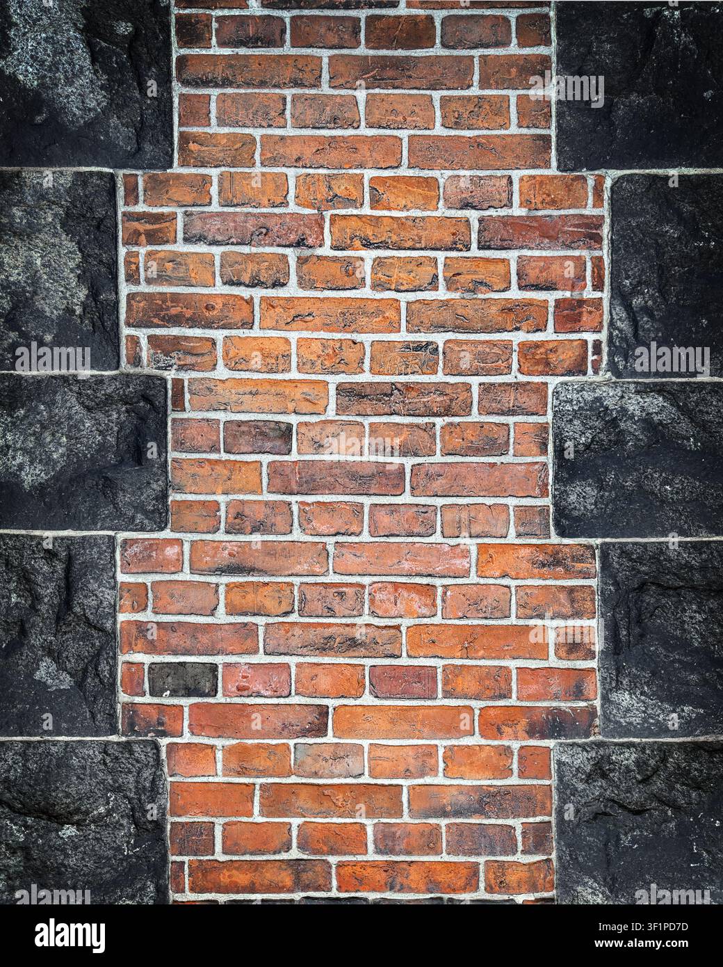 Old Red Brick and Dark Stone Wall Texture Background Stock Photo